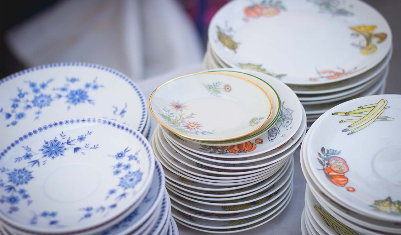 old-china-plates-in-stacks-being-packed-and-moved | Adept Organizer