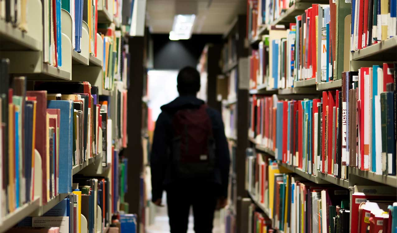 student-in-the-aisles-of-the-library